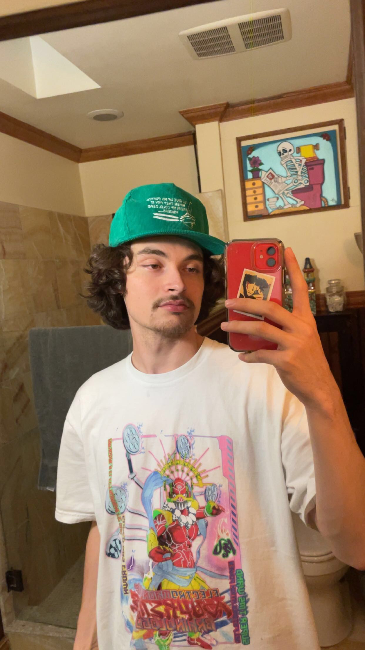 photo of me in a green hat with a white shirt on in a mirror.